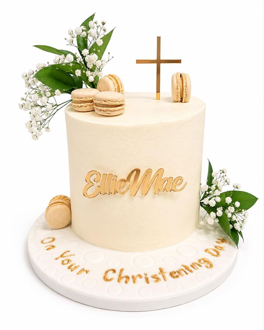Cream christening cake with gold cross and fresh flowers