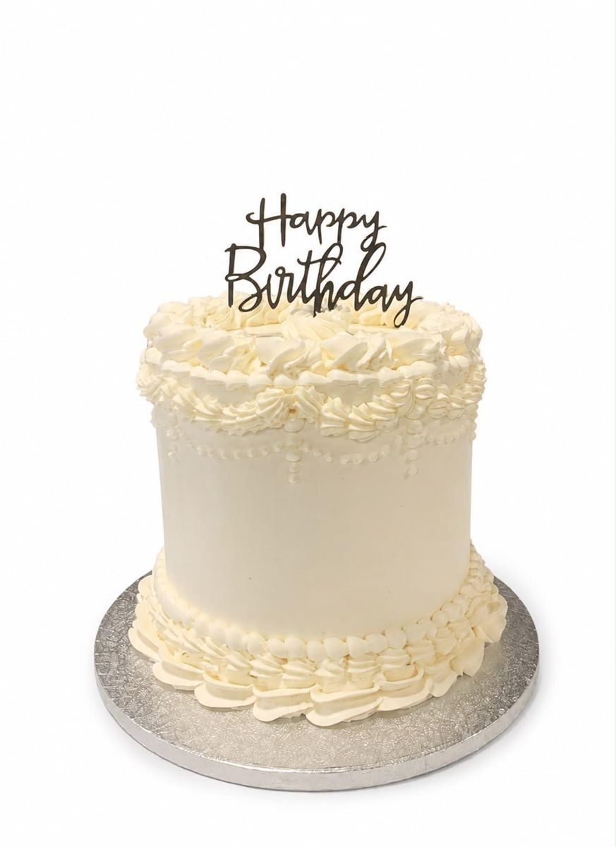 Classic white buttercream birthday cake with topper