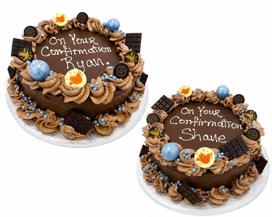 Two chocolate confirmation cakes with piped rosettes and chocolate pieces