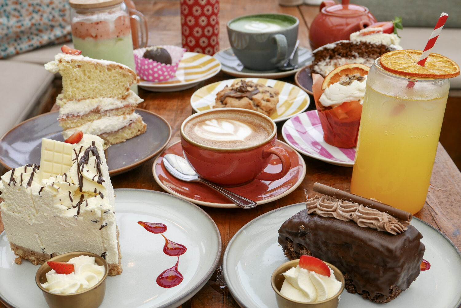 Cake slices, scones and coffee spread across a table at Mason's Apron
