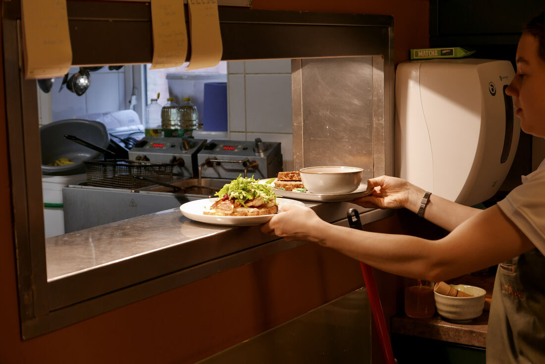 A fresh lunch plate passing over the counter at Mason's Apron